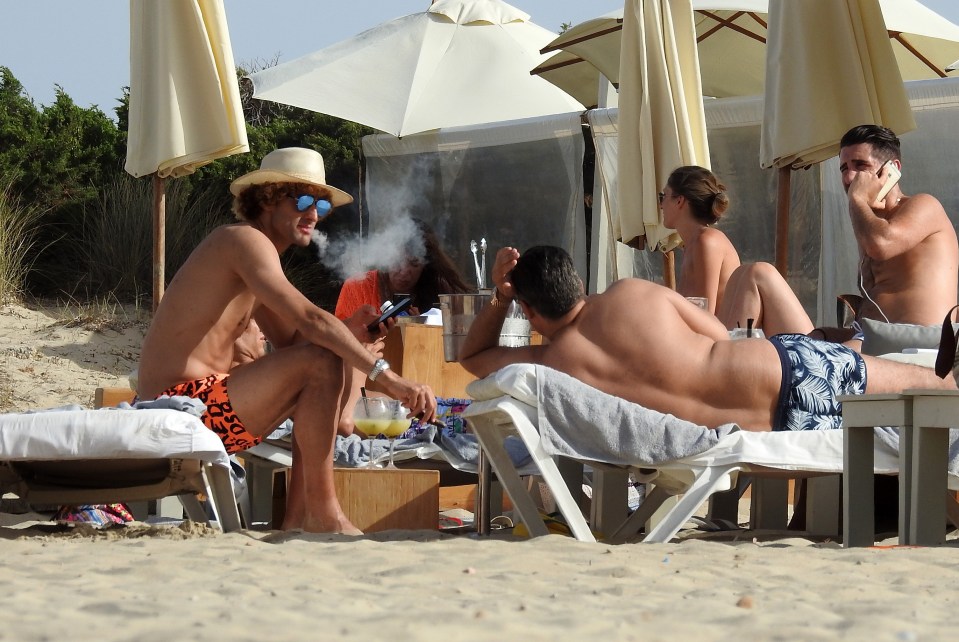  Marouane Fellaini blows cigar out smoke while on holiday with his brother