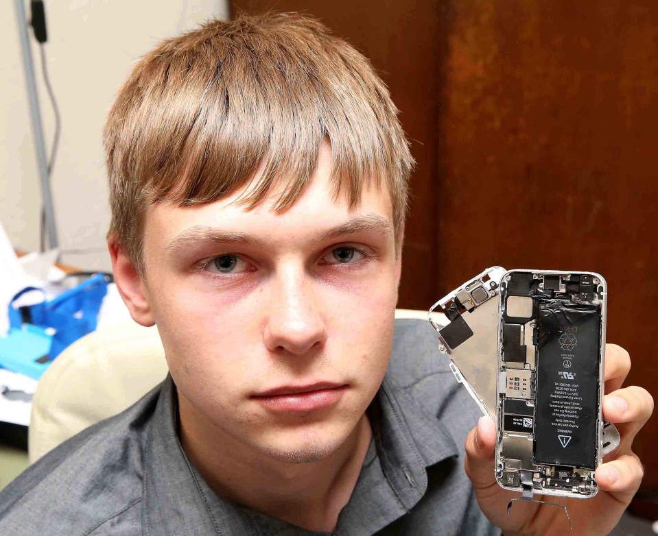 Arthur Smith poses with the wreckage of his iPhone