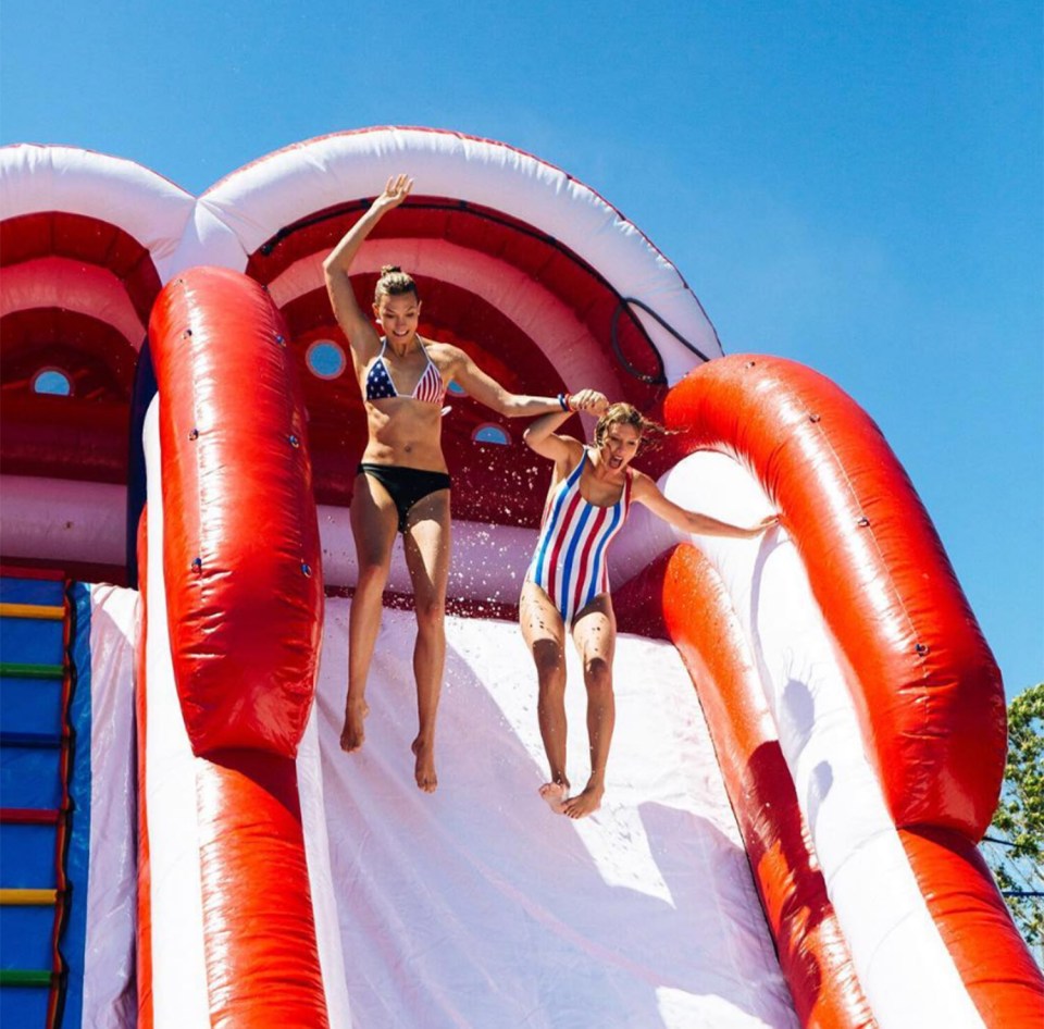  Taylor and model Karlie Kloss enjoy a ride on the water slide