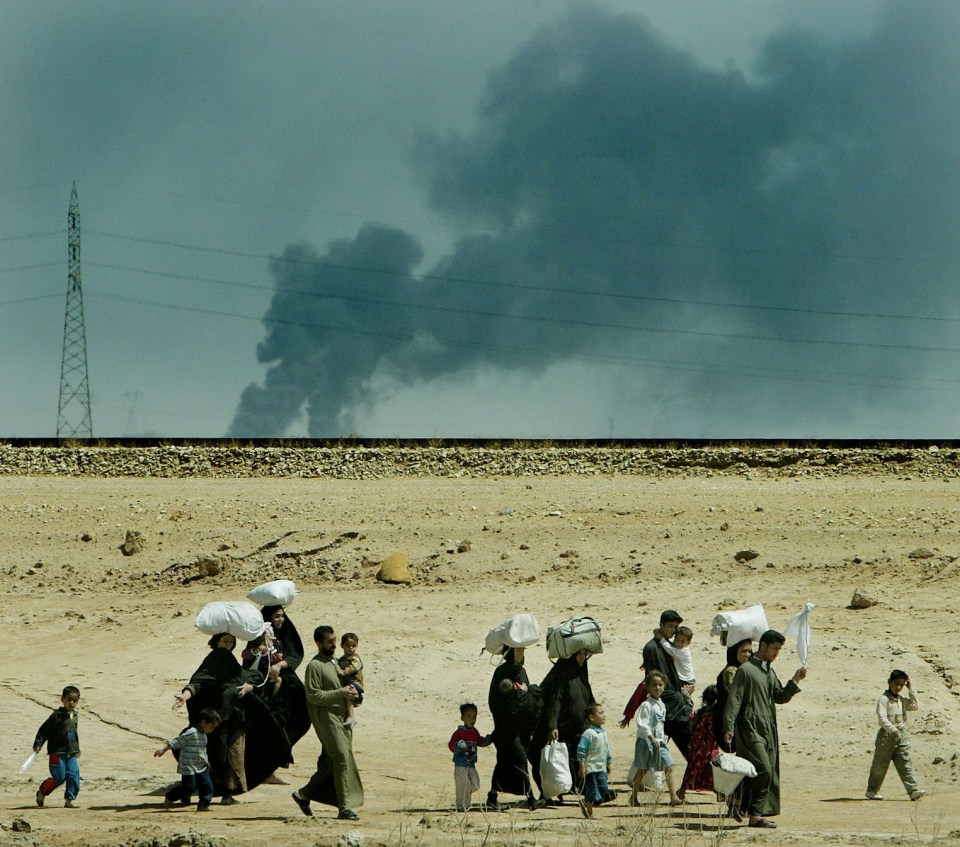  Iraqi locals pictured leaving Basra when the war started in 2003