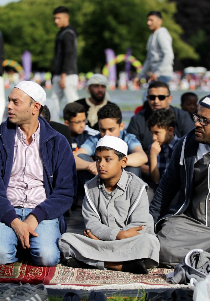  A young boy sits ready to begin his prayers at the massive event in a Birmingham park