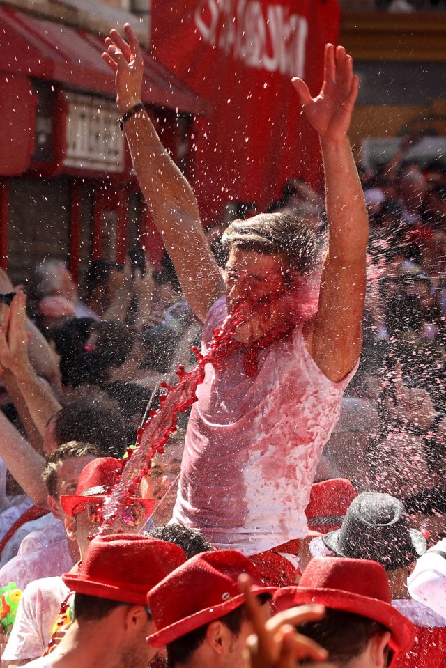  One reveller gets a face-full of wine at the free-flowing festival in the northern Spanish city of Pamplona