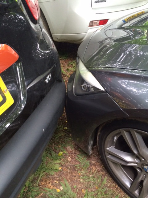  Cars are parked so closely...they are touching bumpers