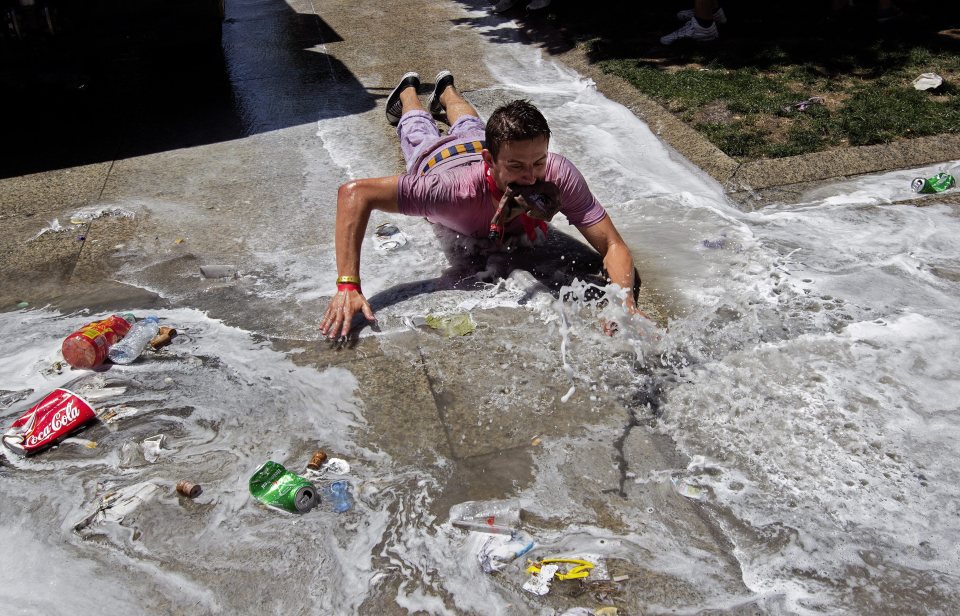  A man decided to slide along on his stomach after water was thrown down to clean the streets