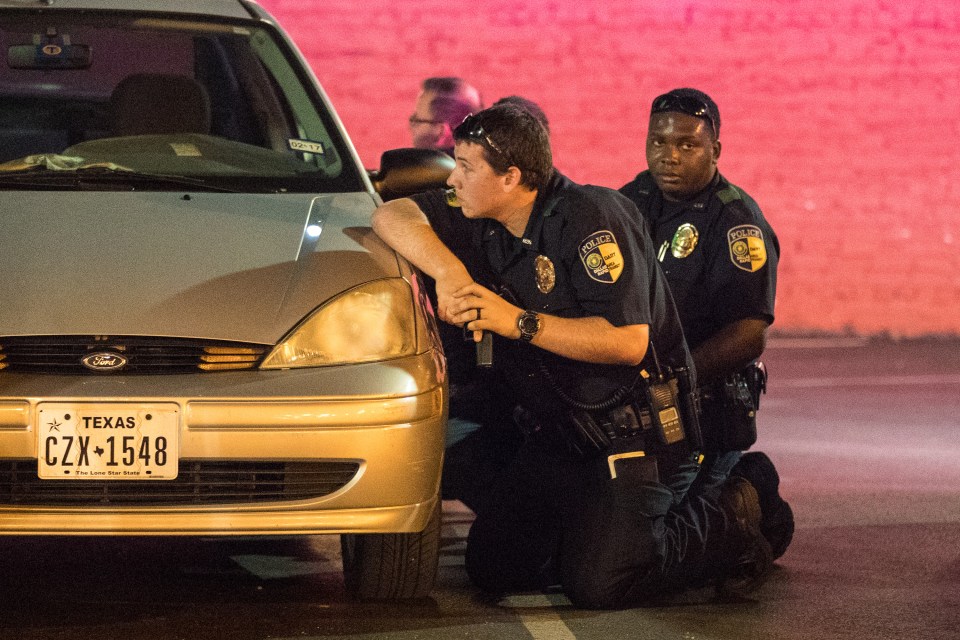  Devastated officers keep watch as sniper remains on the loose