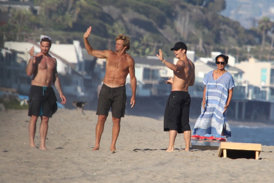  Orlando looked happy and content as he enjoyed a day on the beach with US surf legend Laird Hamilton