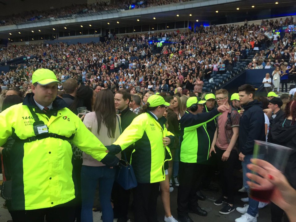  Stewards form a human chain to control the crowd at Hampden Park on Thursday