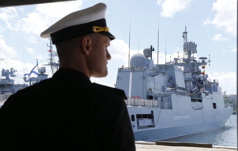  A naval officer inspects a Russian destroyer moored in the Crimea which the Russians seized in 2014