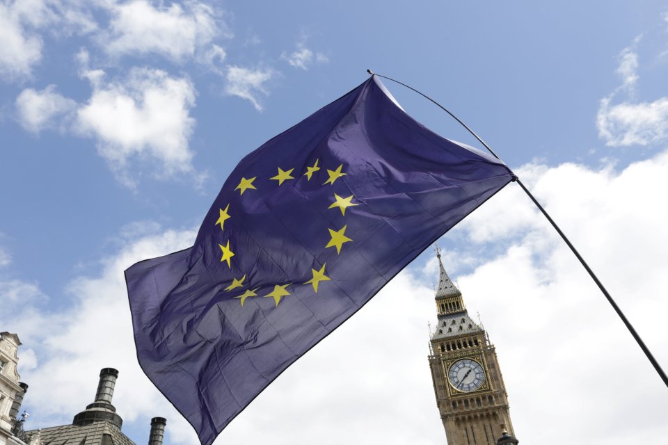 A European Union flag is held in front of the Big Ben clock tower in Parliament Square during a 'March for Europe' demonstration against Britain's decision to leave the European Union, central London