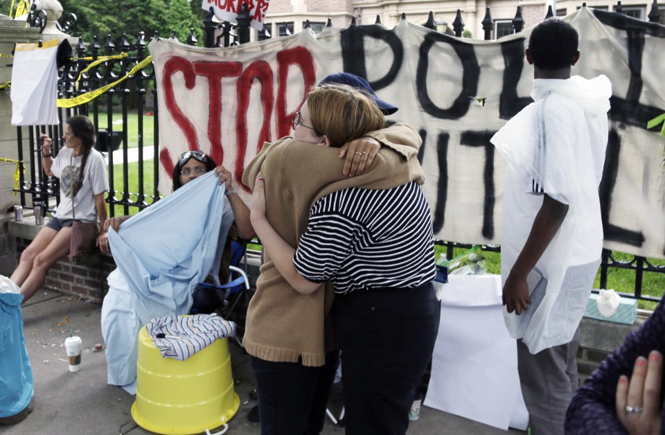  Two people embrace as demonstrators gather outside the governor's residence in Minnesota