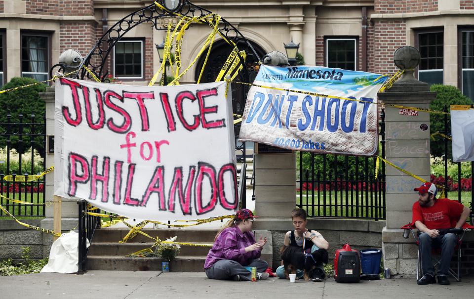  Banners block the entrance gate as demonstrators gather in Minnesota outside the governor's residence