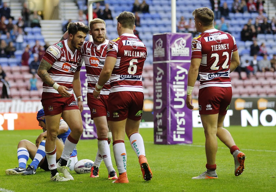  Tomkins (second left) hopes to bring the Challenge Cup back to Wigan