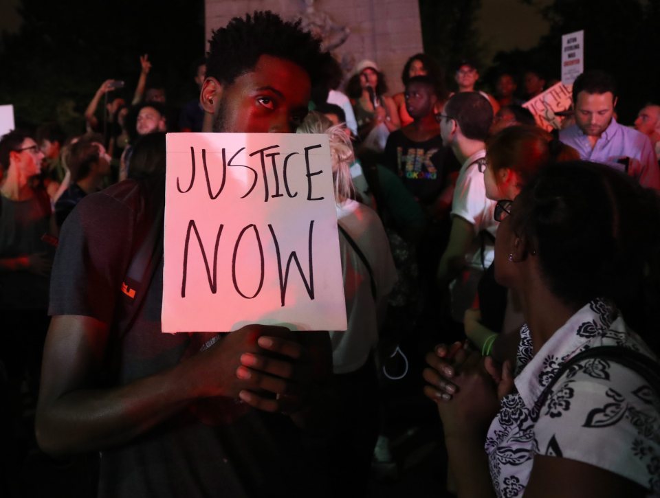  A demonstrator holds a sign during a protest march in the streets of Manhattan, New York