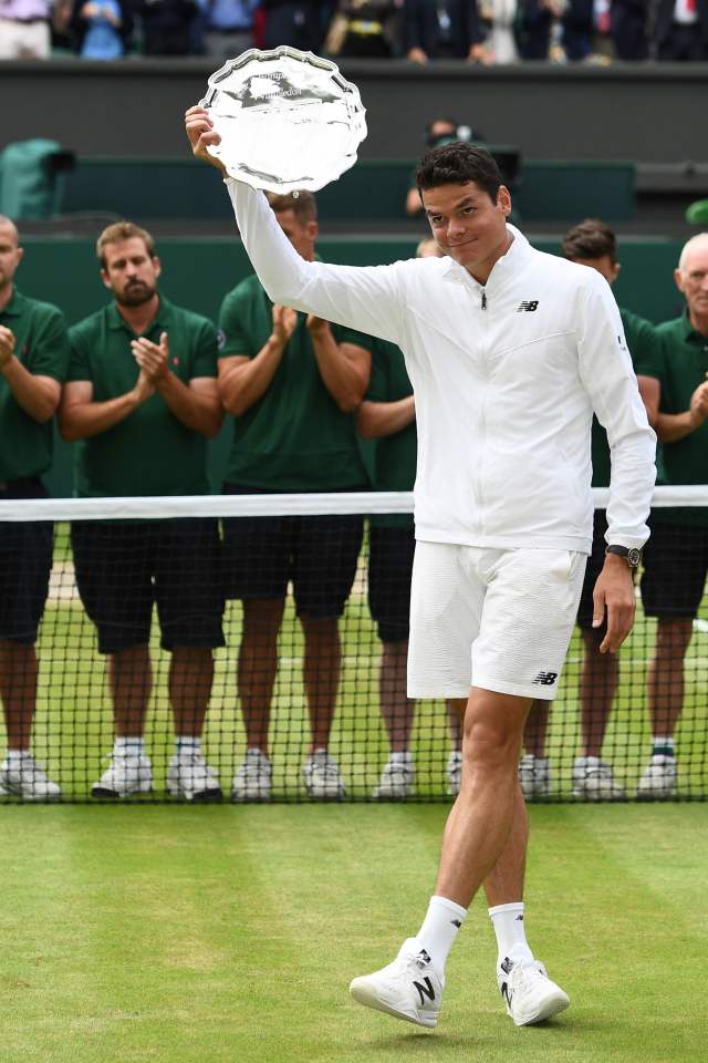  Milos Raonic poses with the runner's up plate after losing to Andy Murray