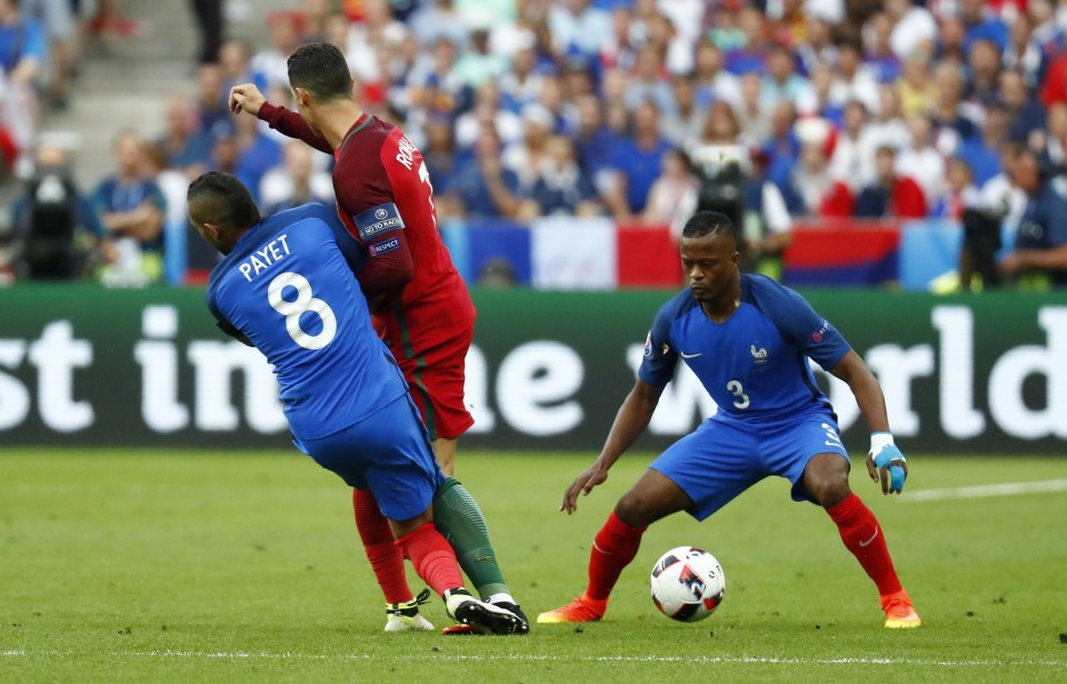  Dimitri Payet's tackle sees his knee collide with Cristiano Ronaldo's