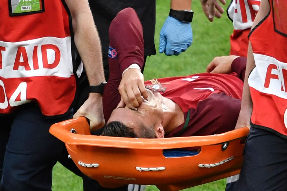  Portugal's physios carry skipper Cristiano Ronaldo off the pitch on a stretcher