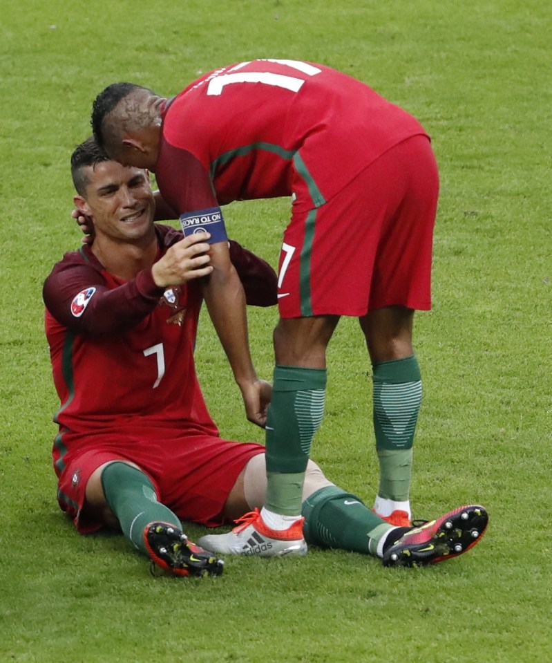 Cristiano Ronaldo hands the armband to Nani as he realises his game is over