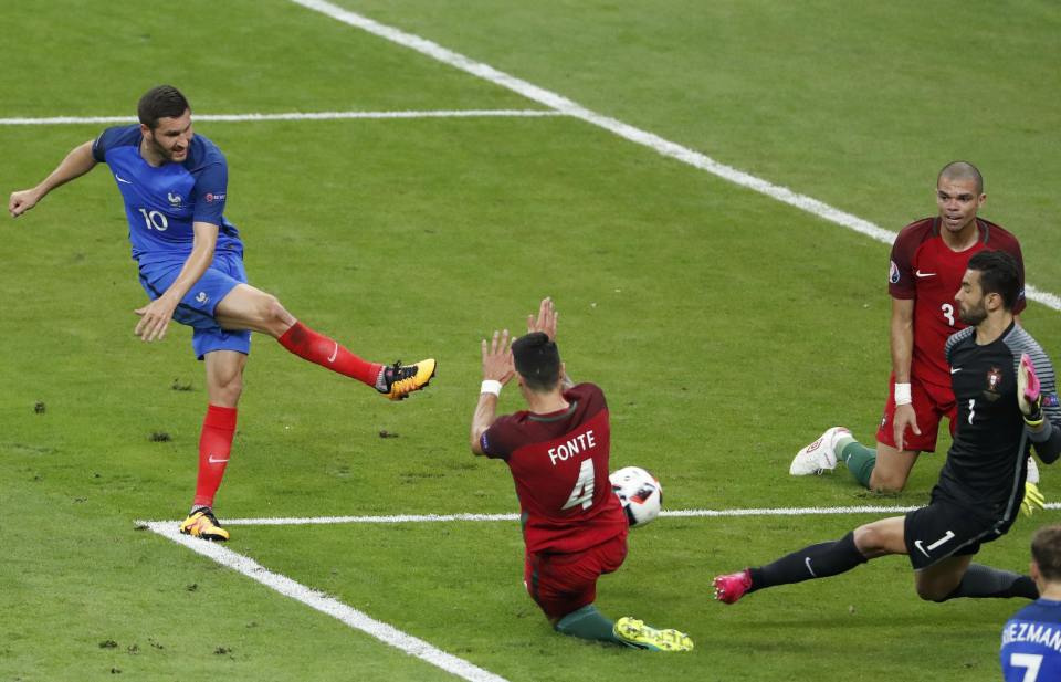 Andre-Pierre Gignac fires against the post in stoppage time for France