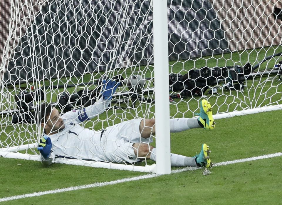 France goalkeeper Hugo Lloris is nestled in the back of the net after he was beaten by Eder's long-range strike