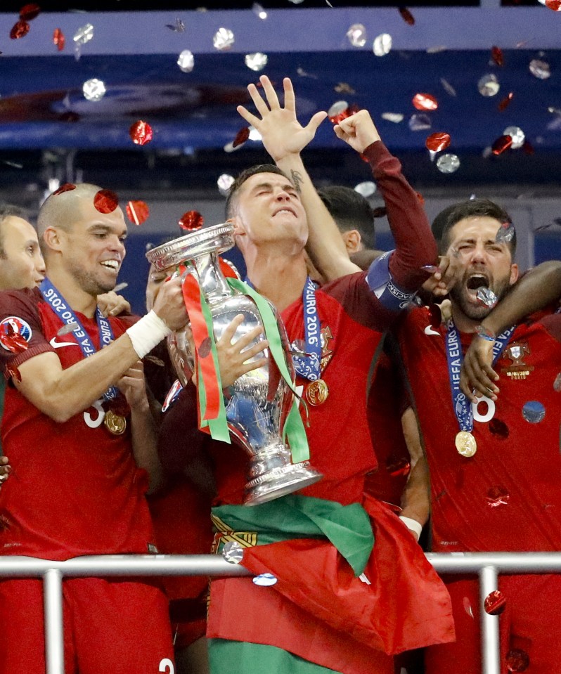 Ronaldo can hardly hide his joy as he lifts the European Championship trophy at the Stade de France