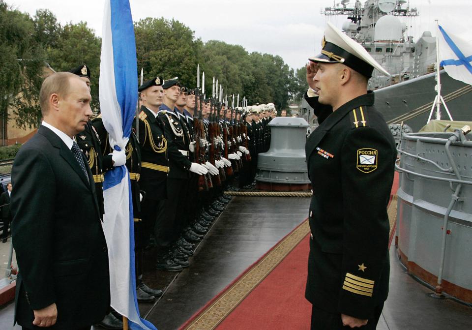  Russian President Vladimir Putin listens to a report from the captain of the destroyer Nastoichivy, the Baltic Fleet flagship, during his visit to the town of Baltiisk outside Kaliningrad in 2006