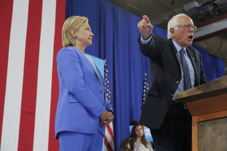  Hillary Clinton watches on as Bernie Sanders explains to his supporters why it's important the Democratic Party unites to stop Donald Trump