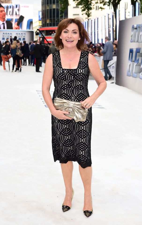  Popular ITV presenter Lorraine Kelly cut a typically chic figure in a lacy black dress which she teamed with a gold bow clutch purse and black and gold heels