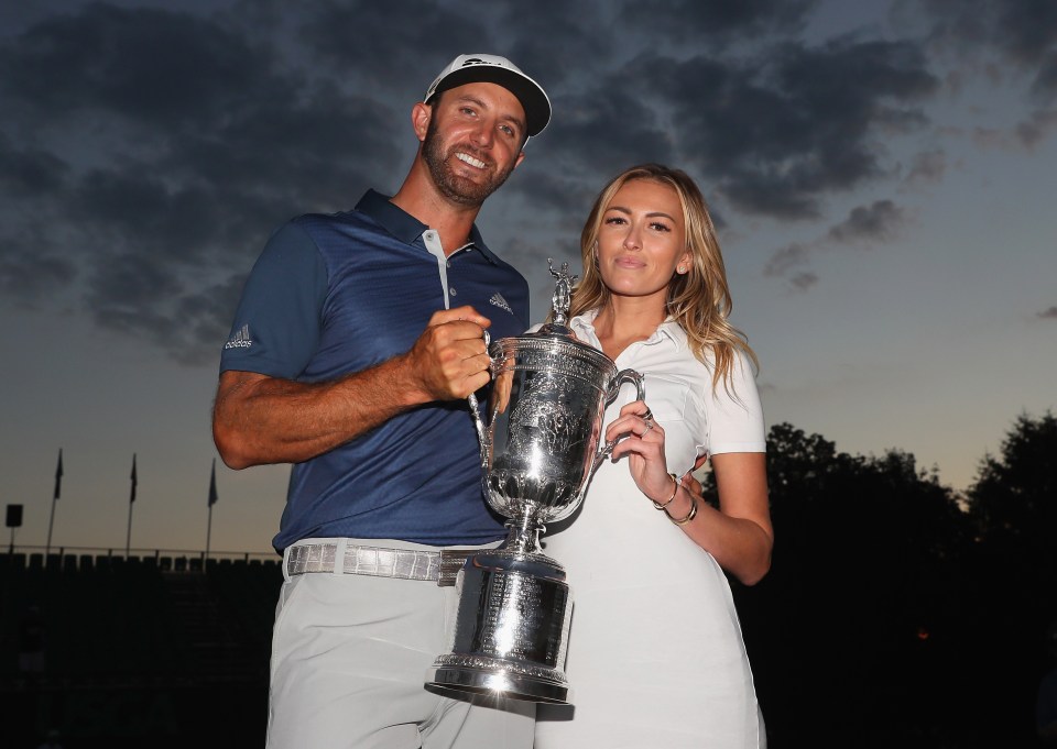 Dustin Johnson shows off his US Open trophy with Paulina