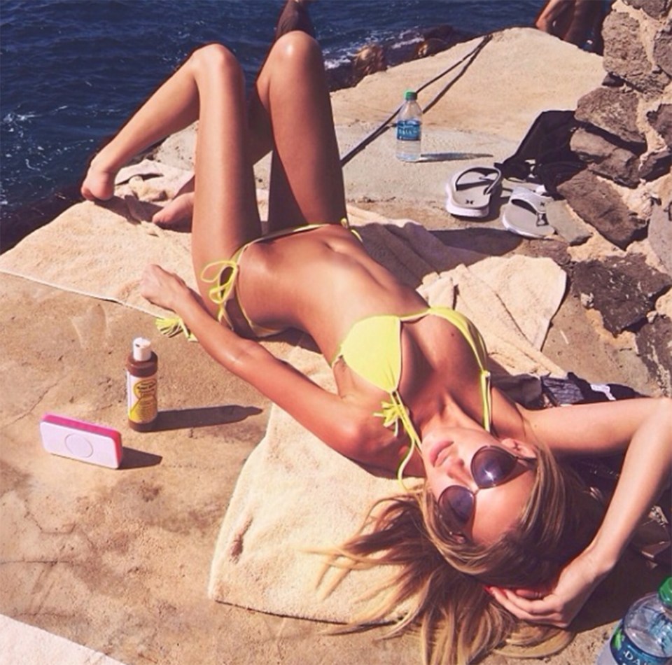  Paulina soaks up the sun in her canary yellow two-piece