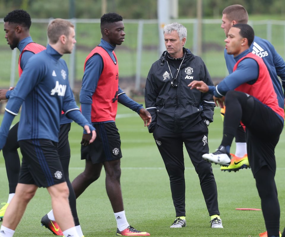  Jose Mourinho watches on as Memphis Depay and fellow United stars perform their warm-up