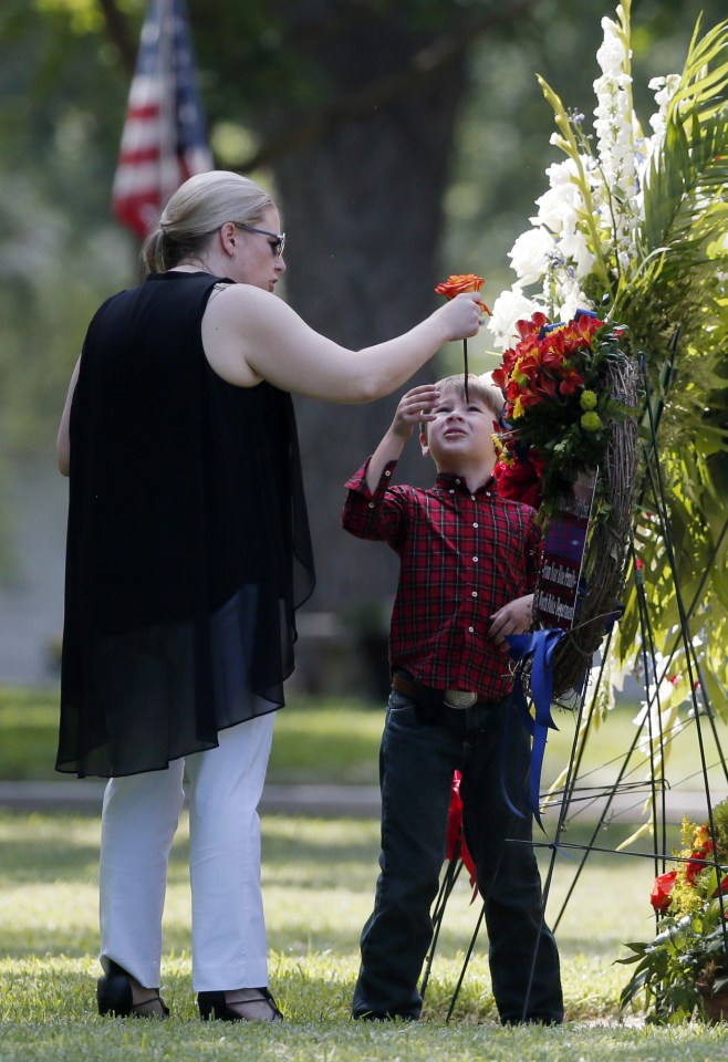  Katrina and her brave boy looks at some of the beautiful flower tributes to fallen Lorne