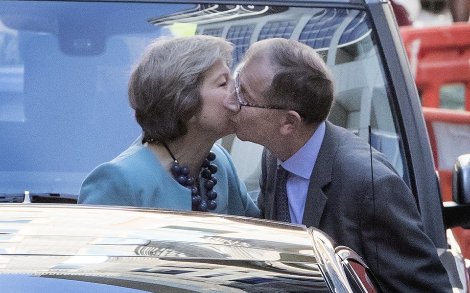  Prime Minister Theresa May kisses her husband Philip before heading to Downing Street where she will be making more Cabinet announcements