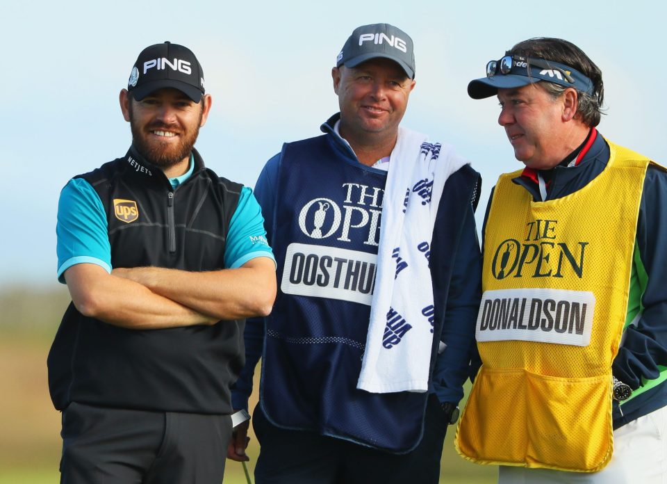 Louis Oosthuizen chats with caddie Greg Hearmon as he reflects on his spectacular 14th hole