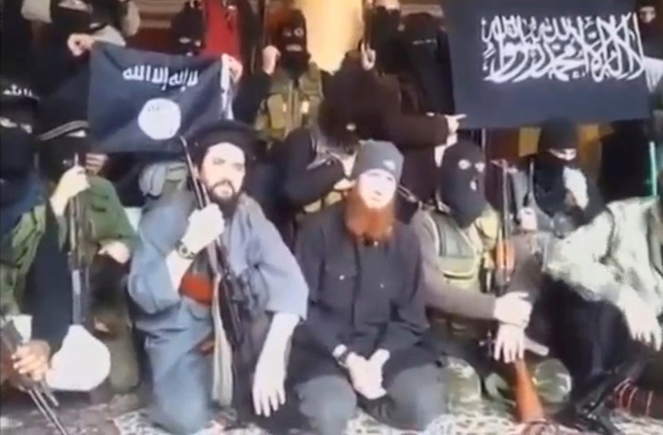  Georgian-born Omar al-Shishani sitting with ISIS fighters