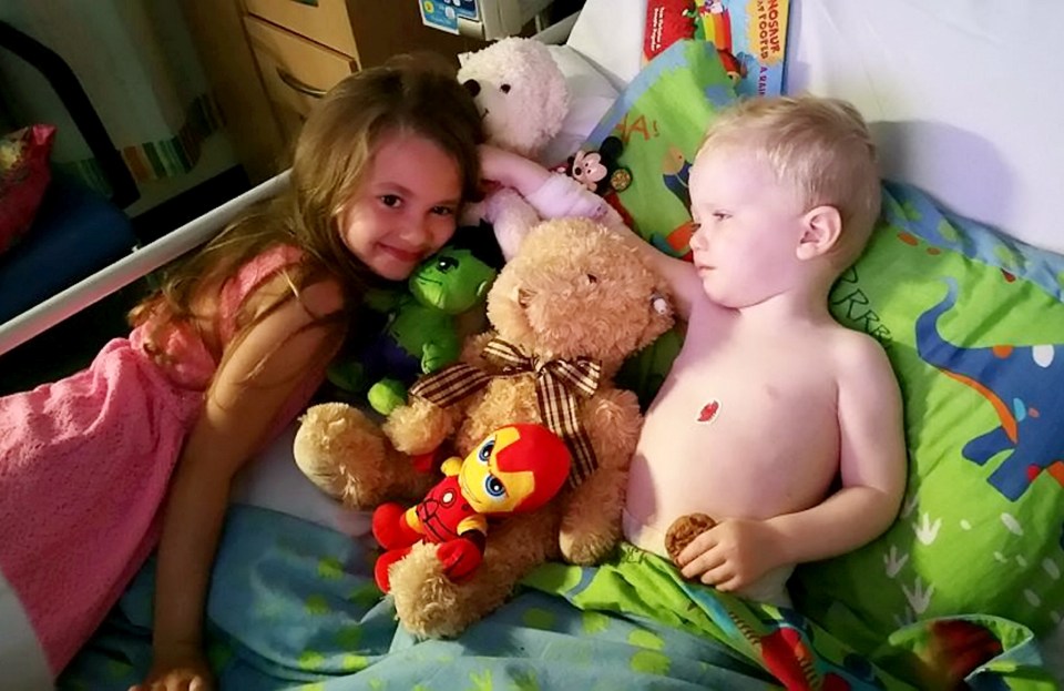  The tot pictured spending time with his big sister Olivia while in hospital in Birmingham