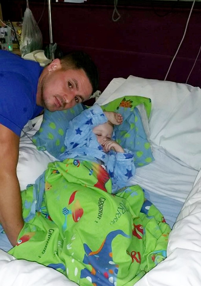  Charlie in hospital, pictured with his dad Ashley, after finally being diagnosed with a tumour in his head