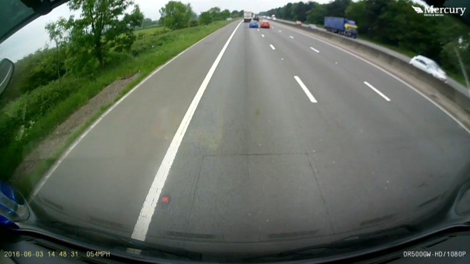  Peugeot driver pulls out to overtake a lorry on the M1, unaware a red car is alongside in the middle lane