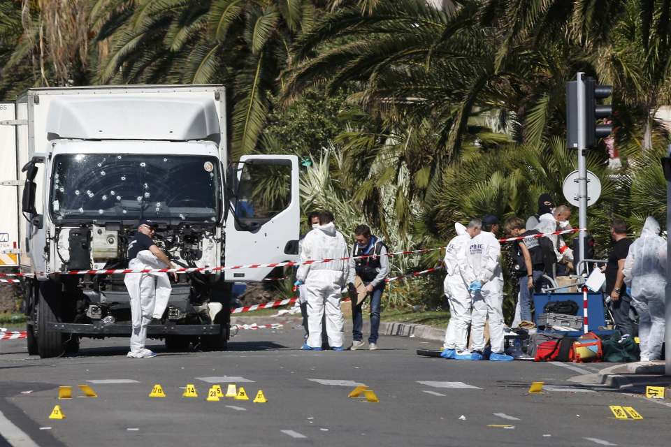 Investigators continue at the scene near the heavy truck that ran into a crowd at high speed killing scores who were celebrating the Bastille Day July 14 national holiday on the Promenade des Anglais in Nice