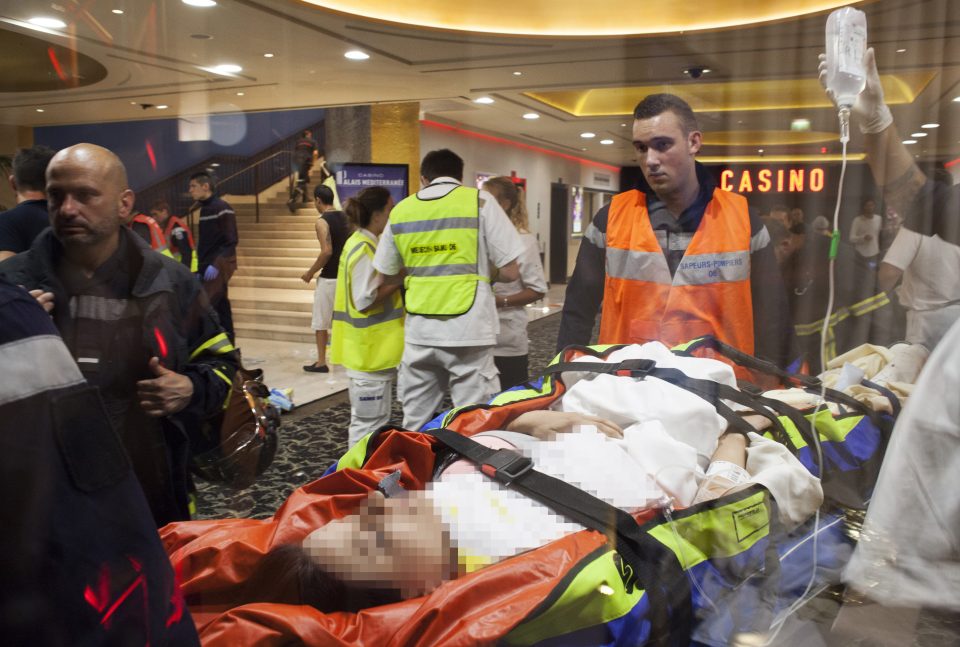  A victim is stretchered to safety by paramedics after being injured in the massacre last night