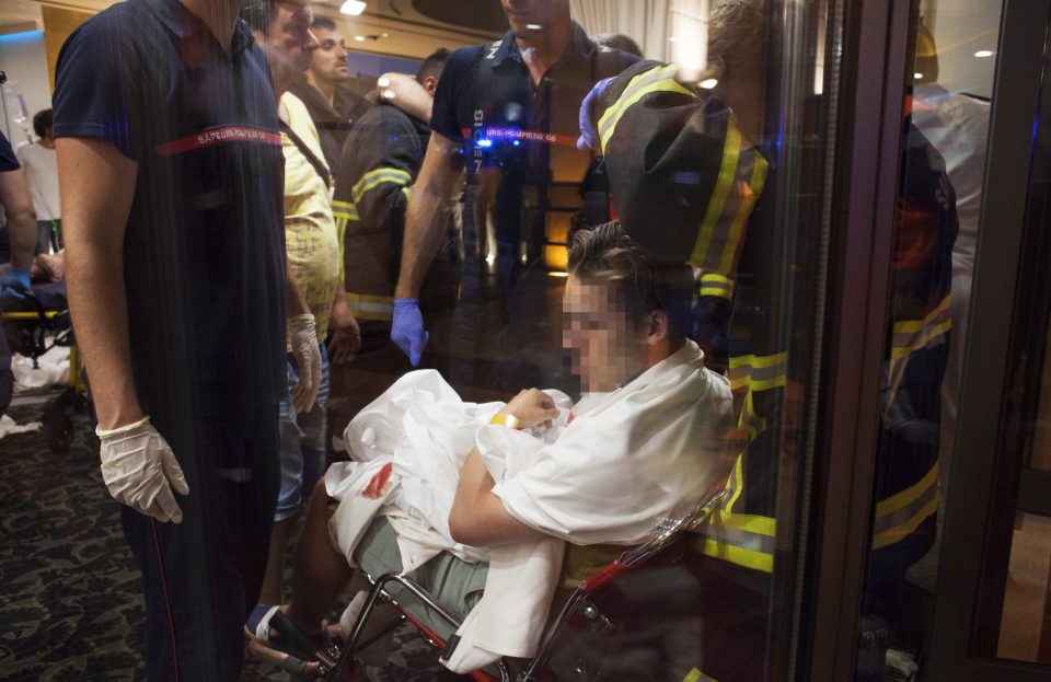  Victims are carried to a makeshift triage area in a nearby hotel at the scene