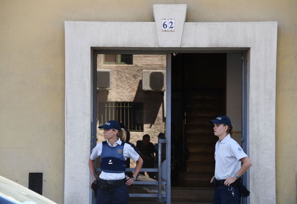  French police officers stand guard outside the apartment of Bastille Day massacre truck driver Mohamed Lahouaiej Bouhlel as they hunt for suspected accomplices