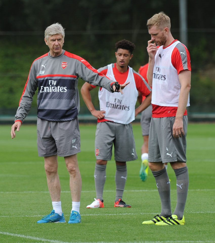  Arsene Wenger talks to Per Mertesacker at Arsenal's London Colney training ground