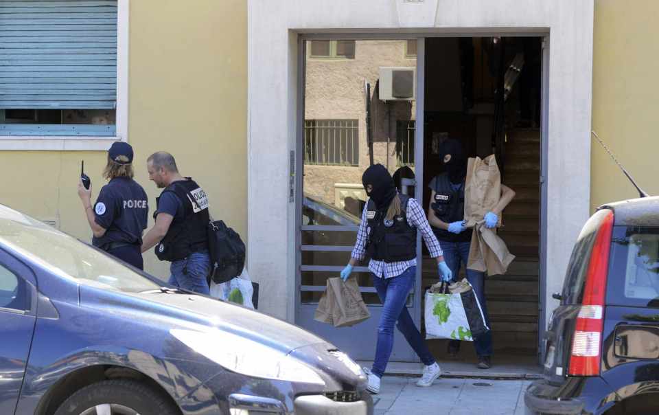  Police carry evidence bags after they conducted a search at Bouhlel's apartment and a truck nearby the day after the massacre