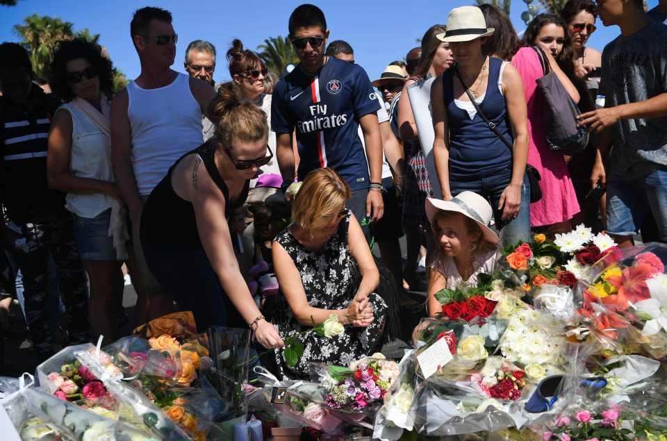  Grief... mourners lay tributes at the scene of the truck massacre on the Promenade des Anglais in Nice