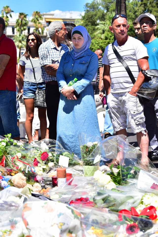 A woman looks on at a make-shift memorial site on July 15