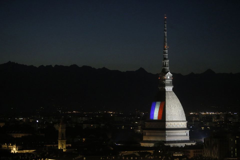 The city of Turin, Italy looks upon the Mole Antonelliana landmark swathed in blue, white and red