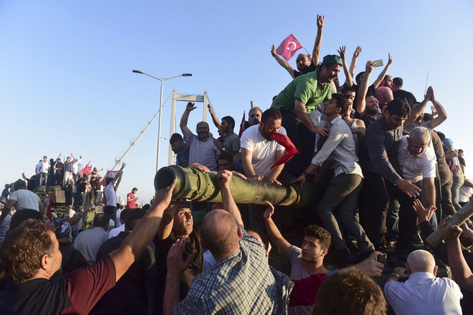  Supporters of President Erdogan cheered, waved flags and mounted tanks left behind by rebels