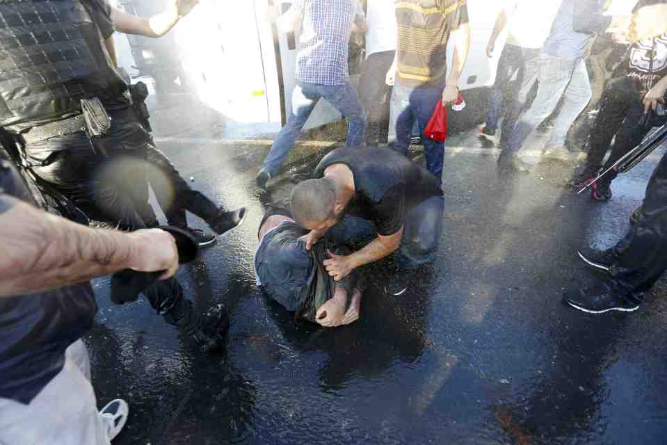  A civilian beats a soldier after the troops surrendered on the Bosphorus Bridge in Istanbul