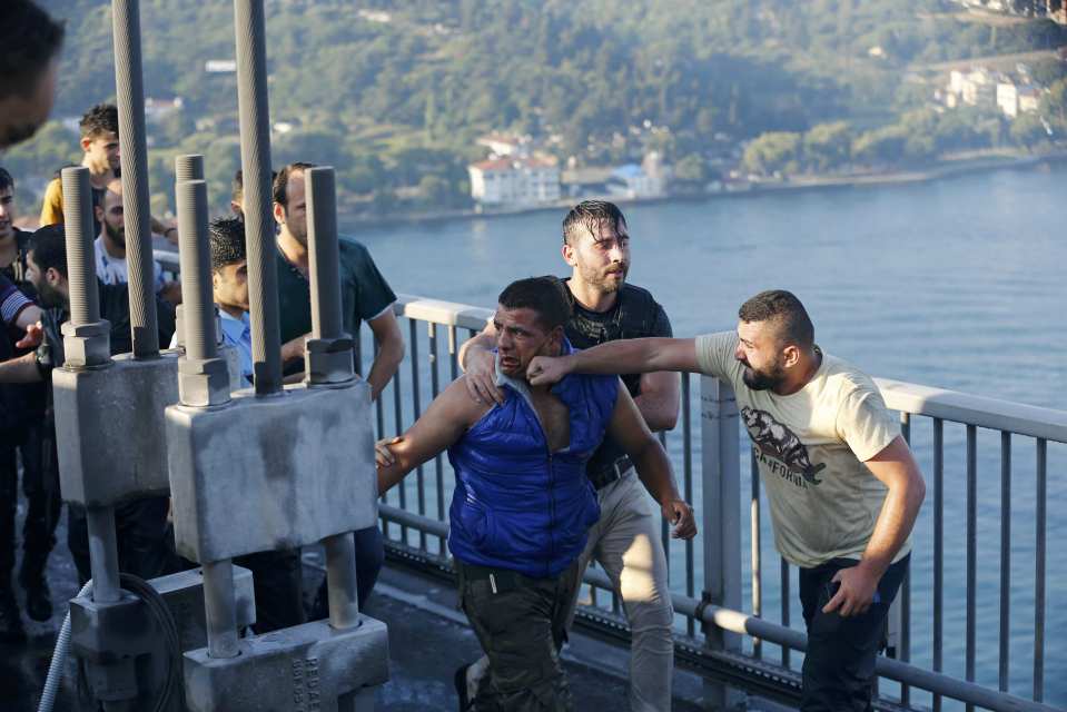  Fists of fury...A civilian beats a soldier who was captured after Friday's failed coup attempt