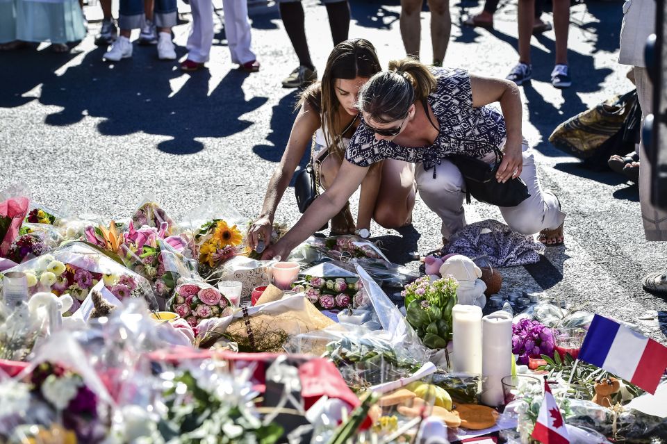  People lay flowers for those killed and injured during the Bastille Day attacks on the Nice promenade